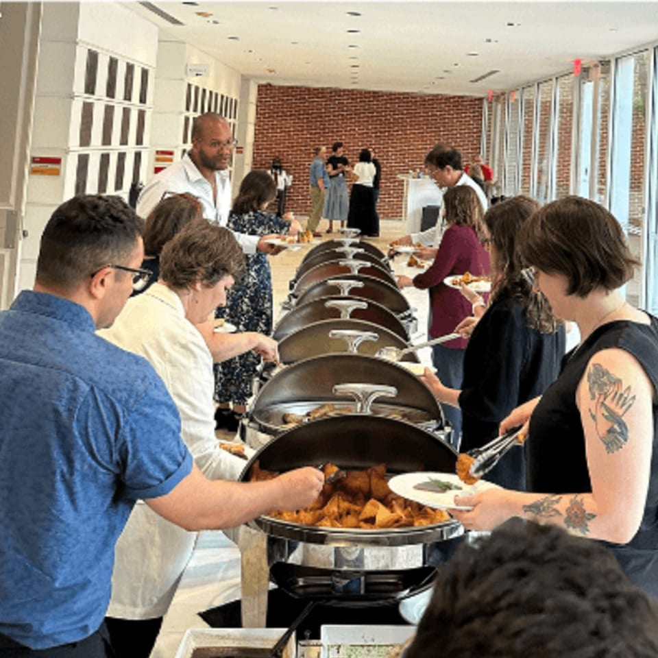 Guests serving themselves Indian food from a buffet line at Rangoli Restaurant.