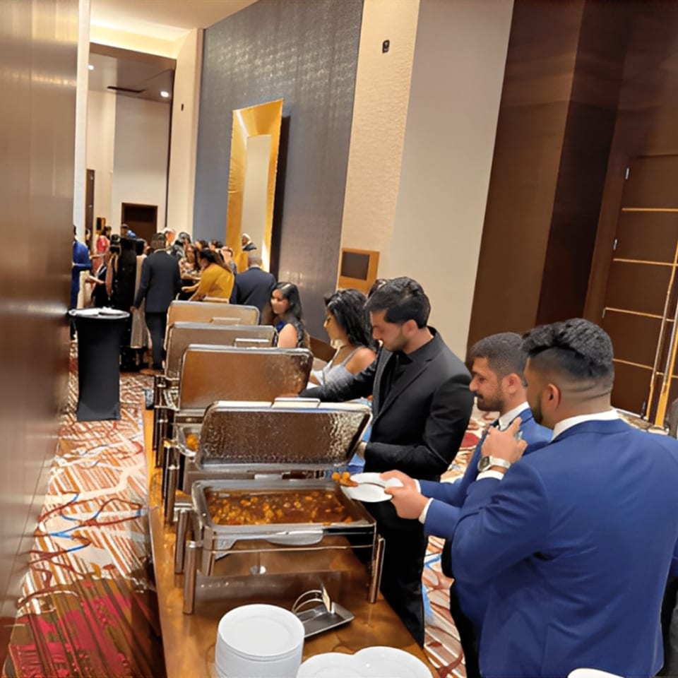 Guests at Rangoli Restaurant's Indian buffet, serving themselves from chafing dishes.